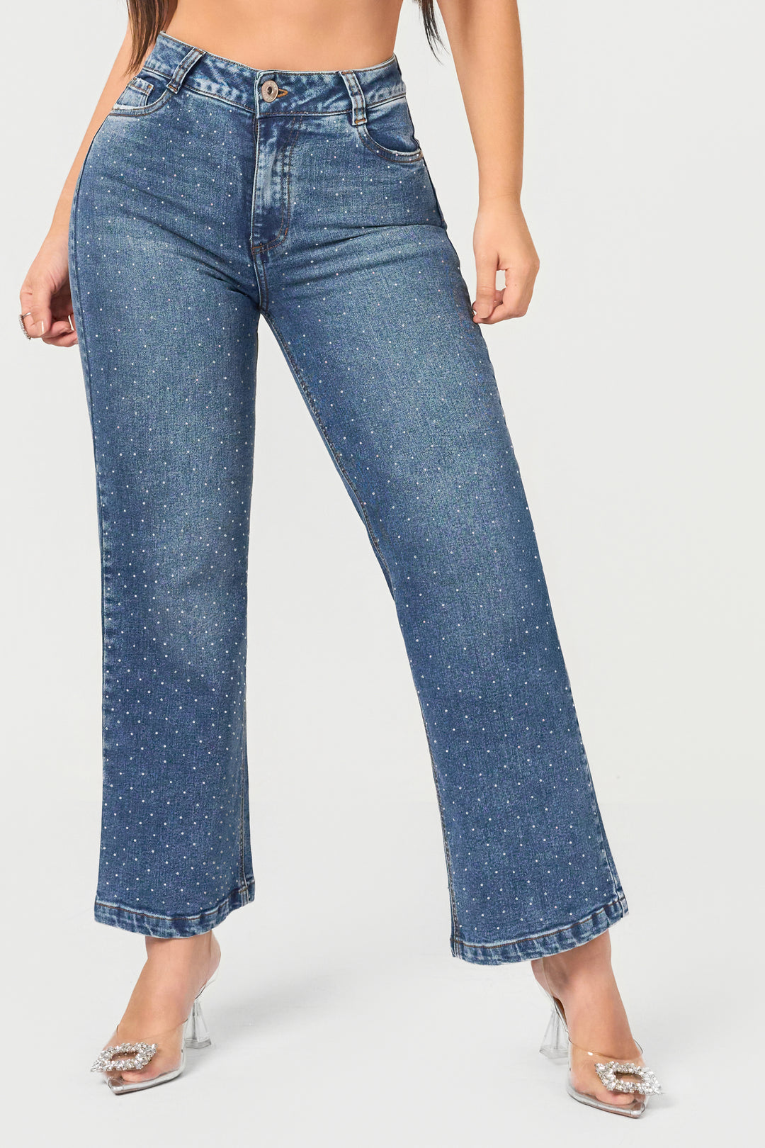 Colombian straight jeans with high waist and rhinestone details. Elegant blue denim that sparkles with subtle luxury.