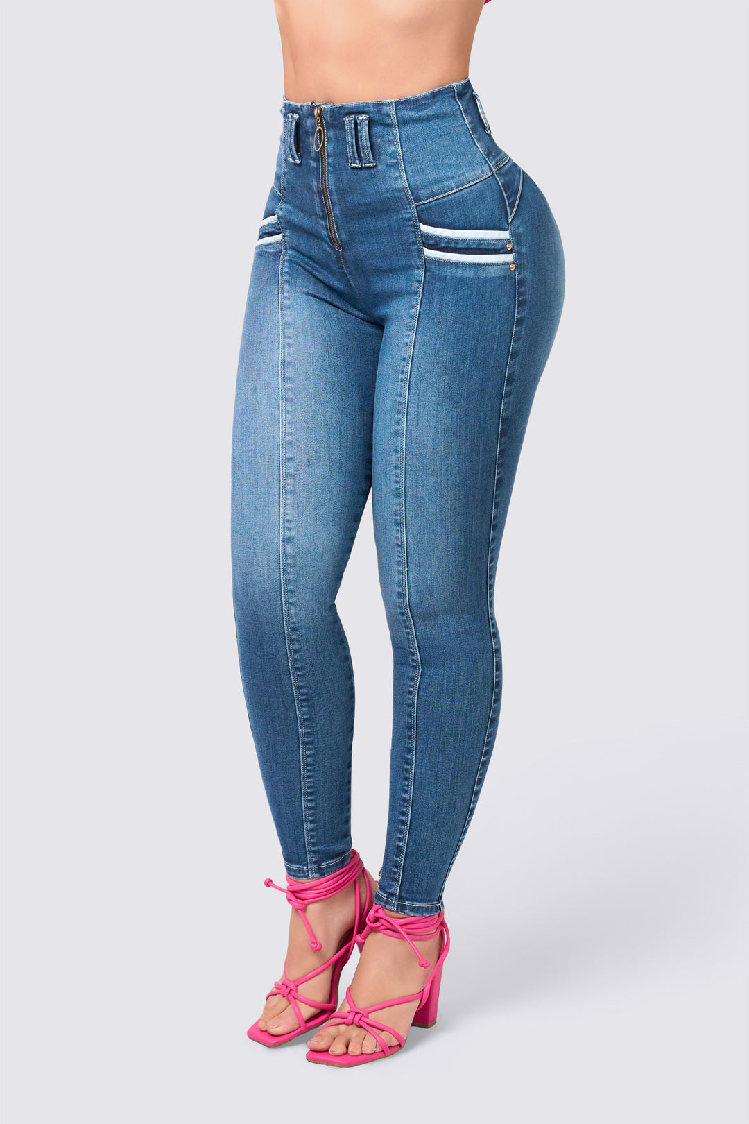Blue skinny jeans with a high waist, front closure, and seams that elongate the figure. 