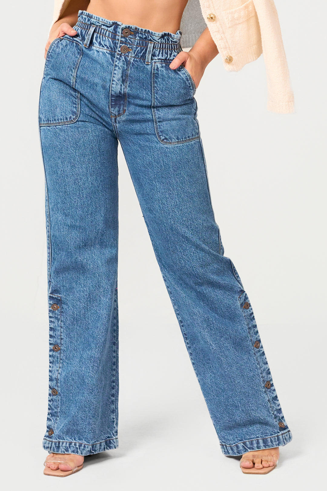 High-rise wide leg jeans with paperbag waist and button details. Stylish denim with a relaxed fit for effortless everyday fashion.