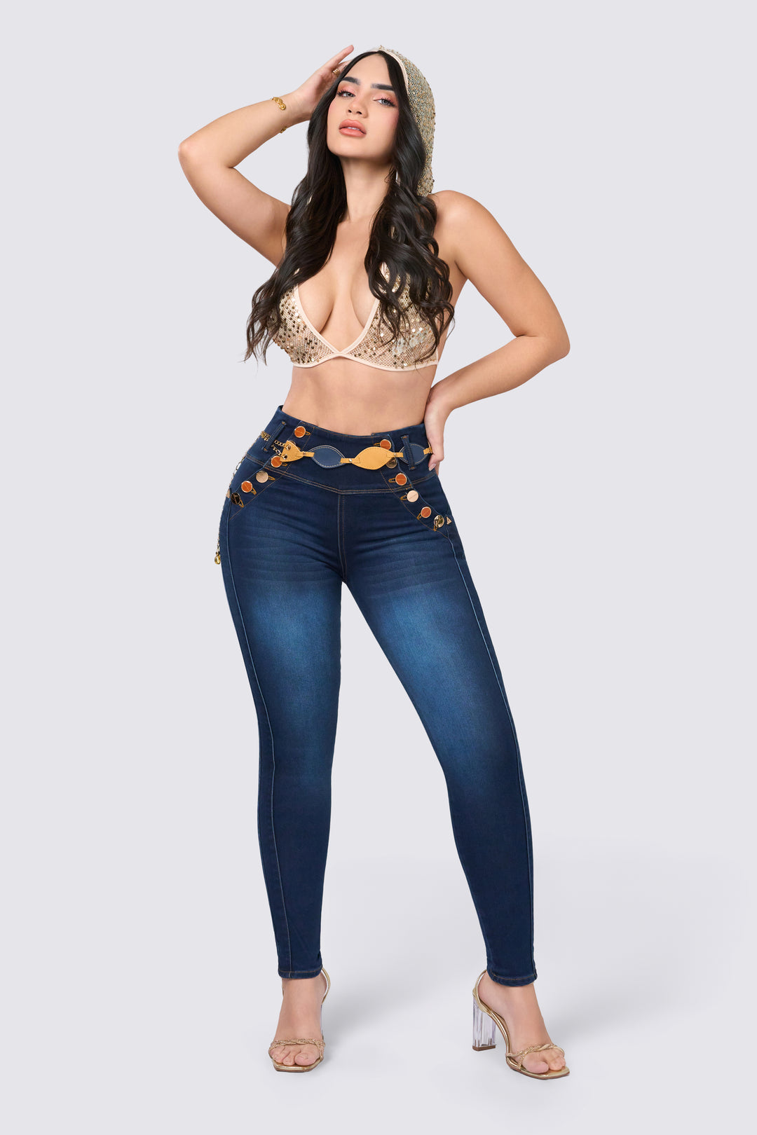 Dark blue skinny jeans with a high waistband, front buttons, and belt loops. 