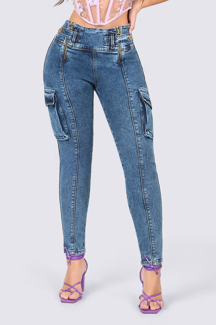 Distressed blue skinny jeans with cargo-style pockets and a high waistband featuring front zippers. 