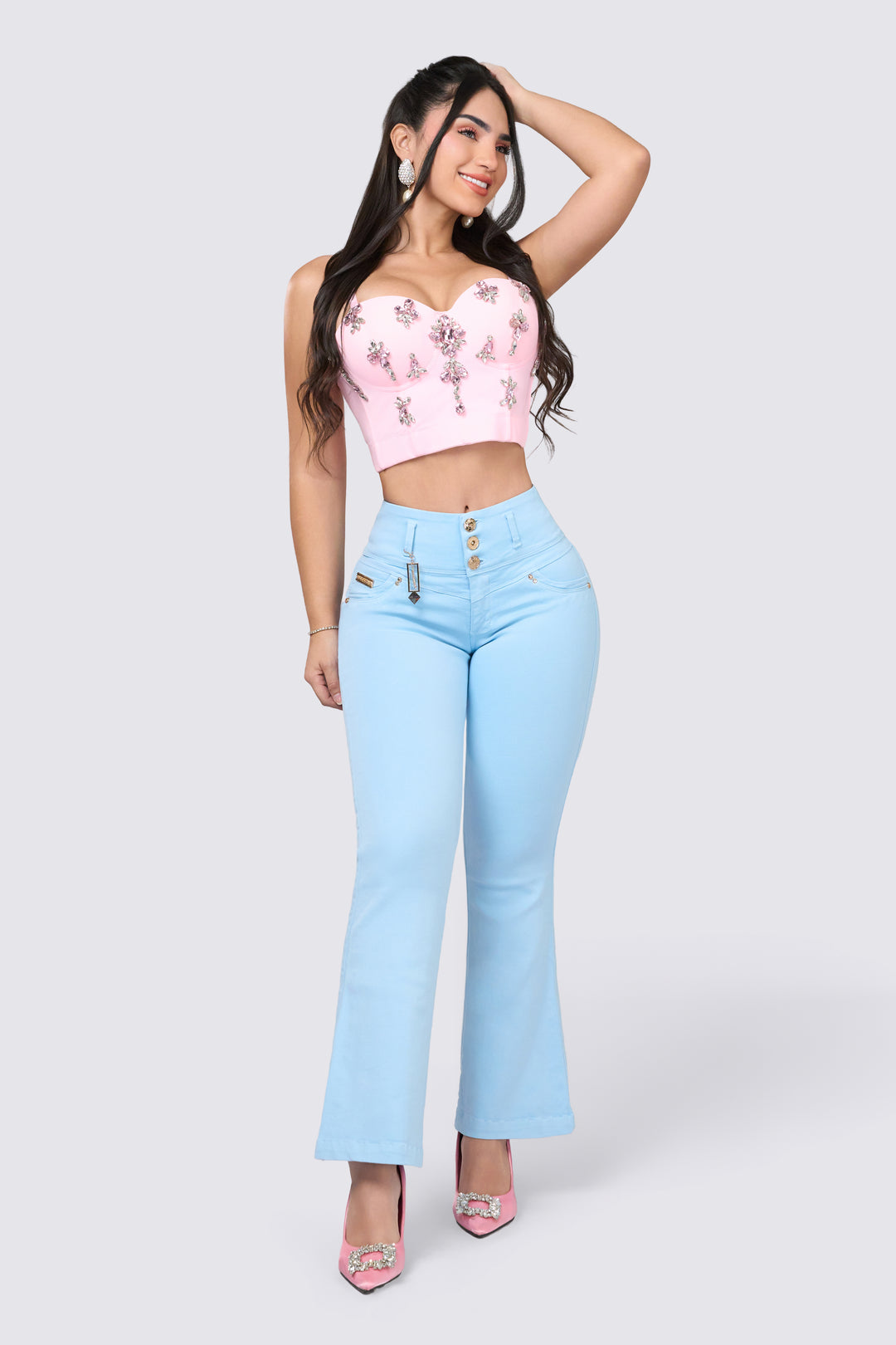 High-waisted pants with a high rise, wide waistband with three buttons, and light blue color. 