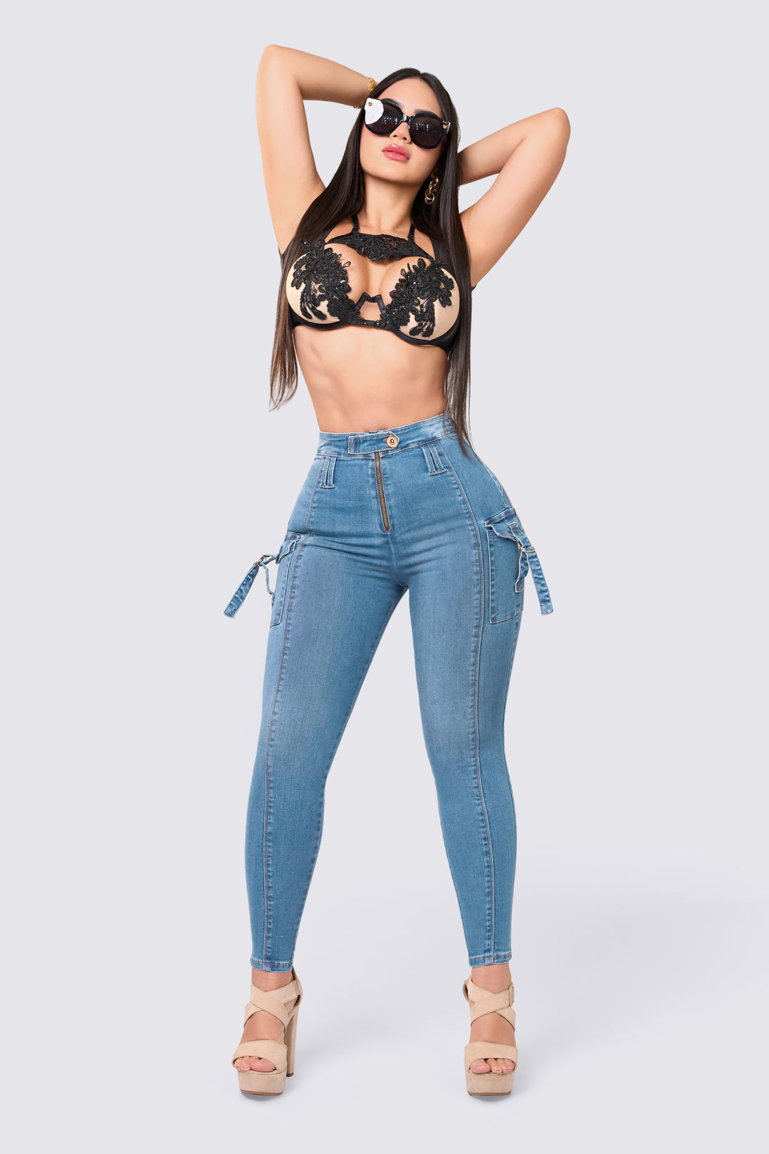 Light blue skinny jeans, high rise, slim waistband, cargo-style side pockets. 