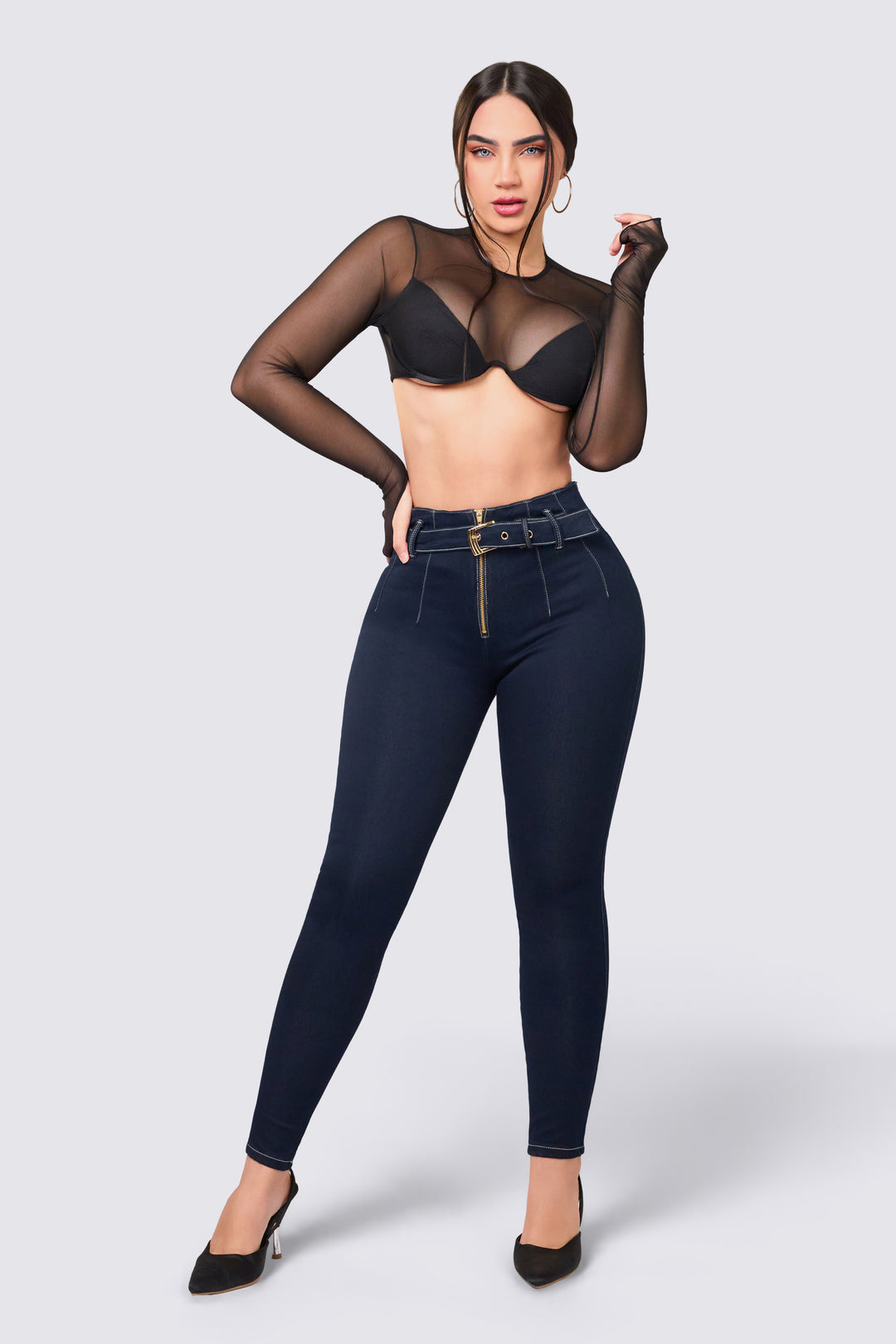 Dark blue skinny jeans with front zipper and denim belt.