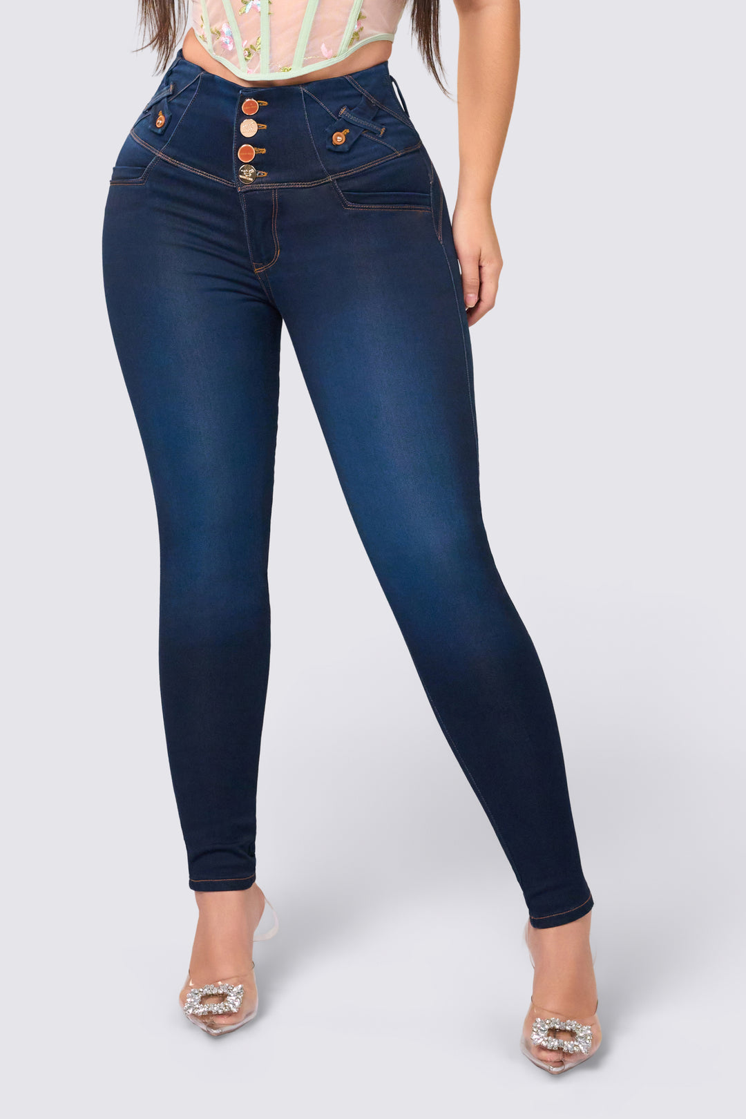 Dark blue skinny jeans with a high waist, wide waistband, and push-up butt lift. 
