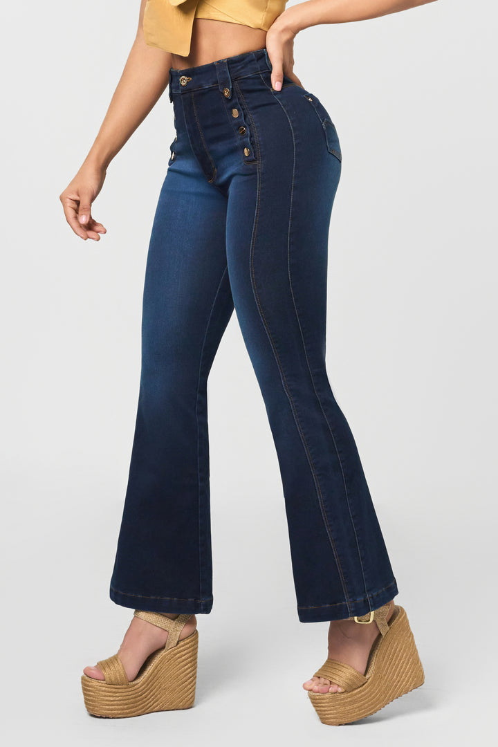 Dark blue jeans with 7 front buttons, flared legs, and seams that elongate the silhouette. 