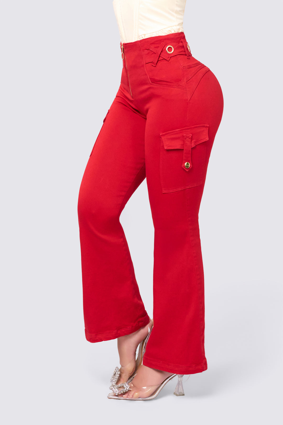 High-waisted red jeans with flared legs and cargo-style pockets on the sides. 
