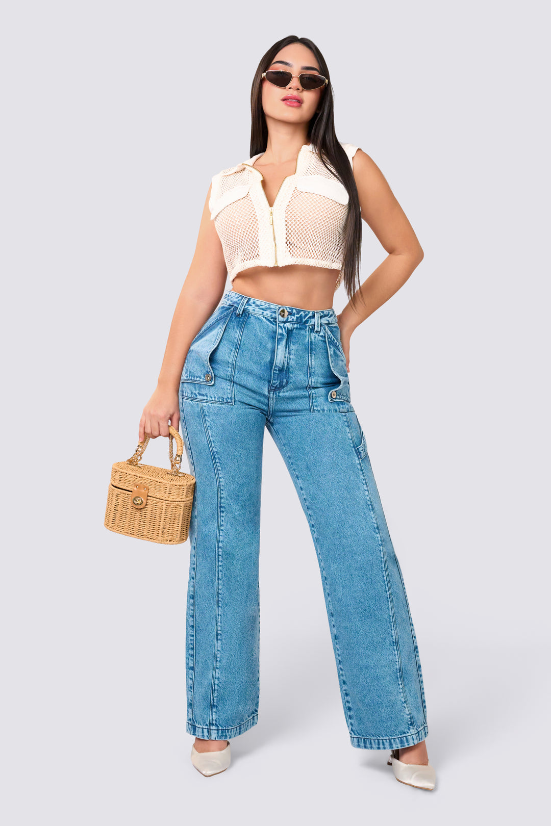 High-waisted jeans in a wide-leg style with a washed blue color, seams along the length of the jeans that elongate the legs for a stylish touch. 